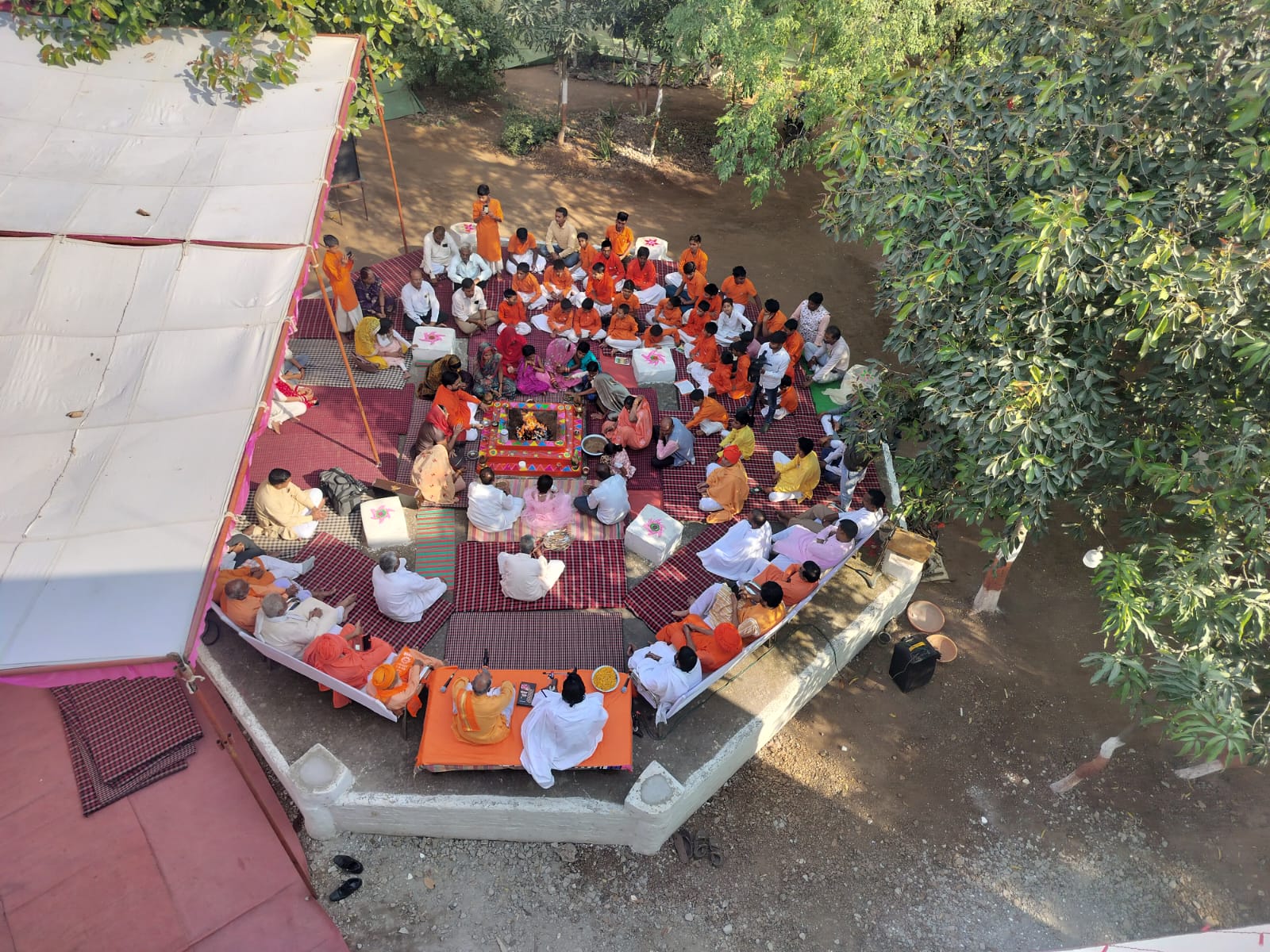 Aerial view of large outdoor ceremony with organized seating arrangement