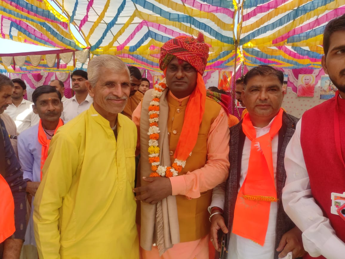 Officials and dignitaries at ceremonial gathering with traditional attire