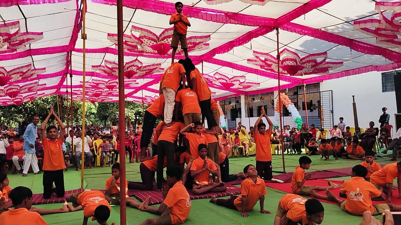 Students performing physical education exercises and human pyramid formations