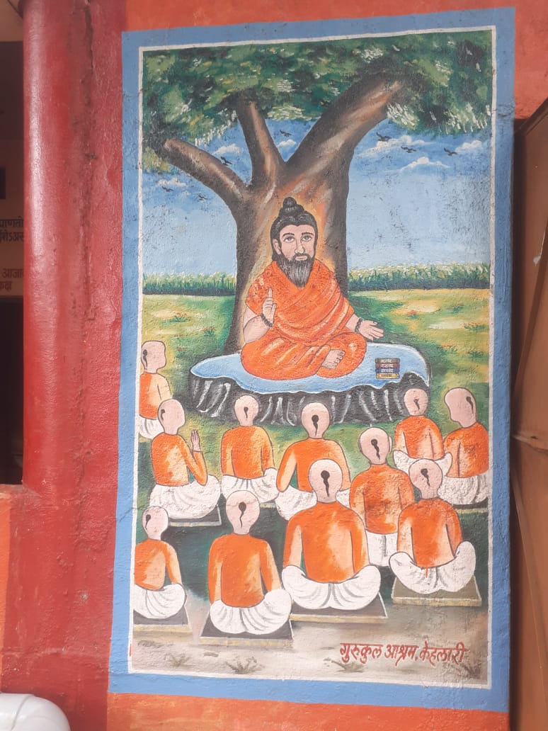 Traditional mural showing guru teaching students under tree